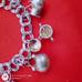 Vtg Sterling Silver Double Linked Charm Bracelet with 9 Sterling Silver Charms.