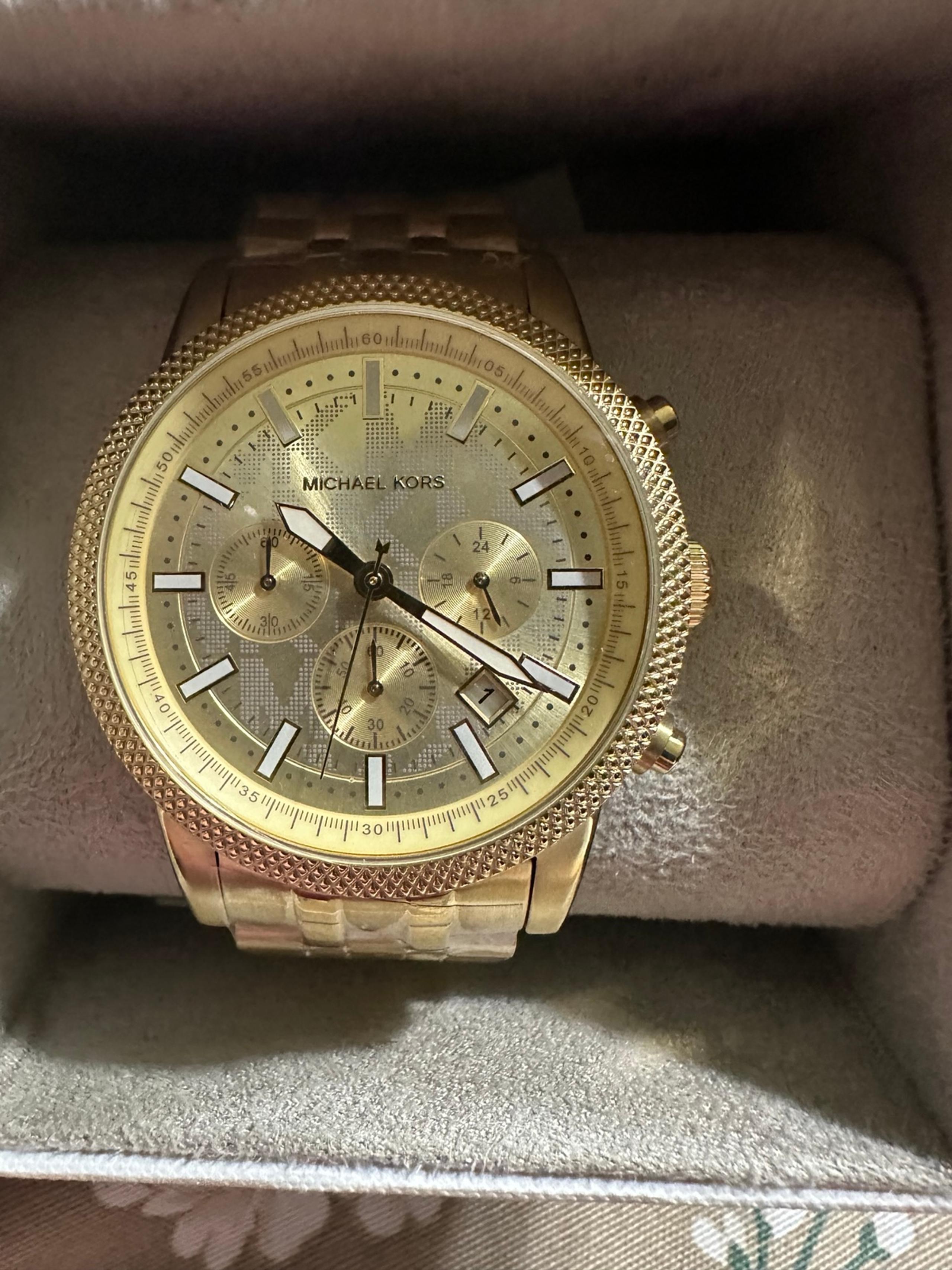 Michael Kors stainless steel gold toe men’s watch with date on the face