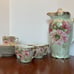 Chocolate or tea pot with cups and saucers