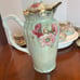 Chocolate or tea pot with cups and saucers
