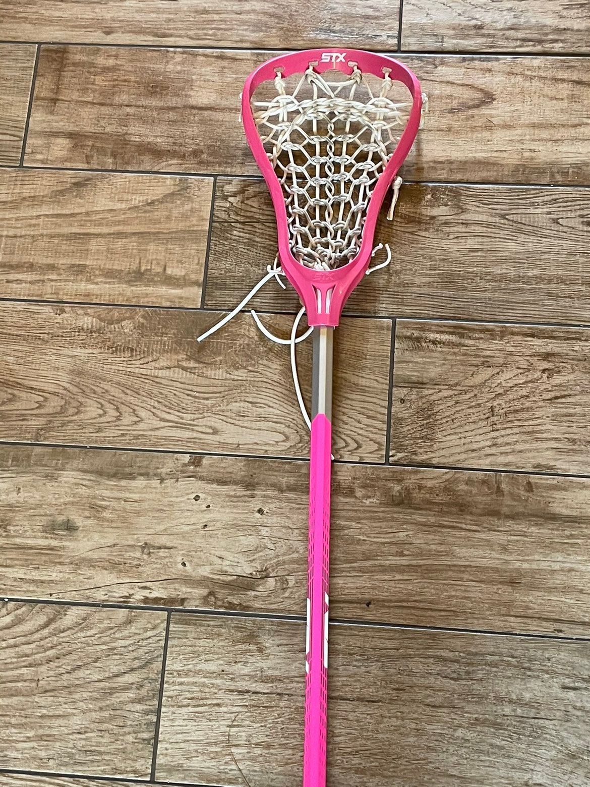 Pink lacrosse stick with googles