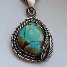 Solid sterling artisan made turquoise pendant and chain.