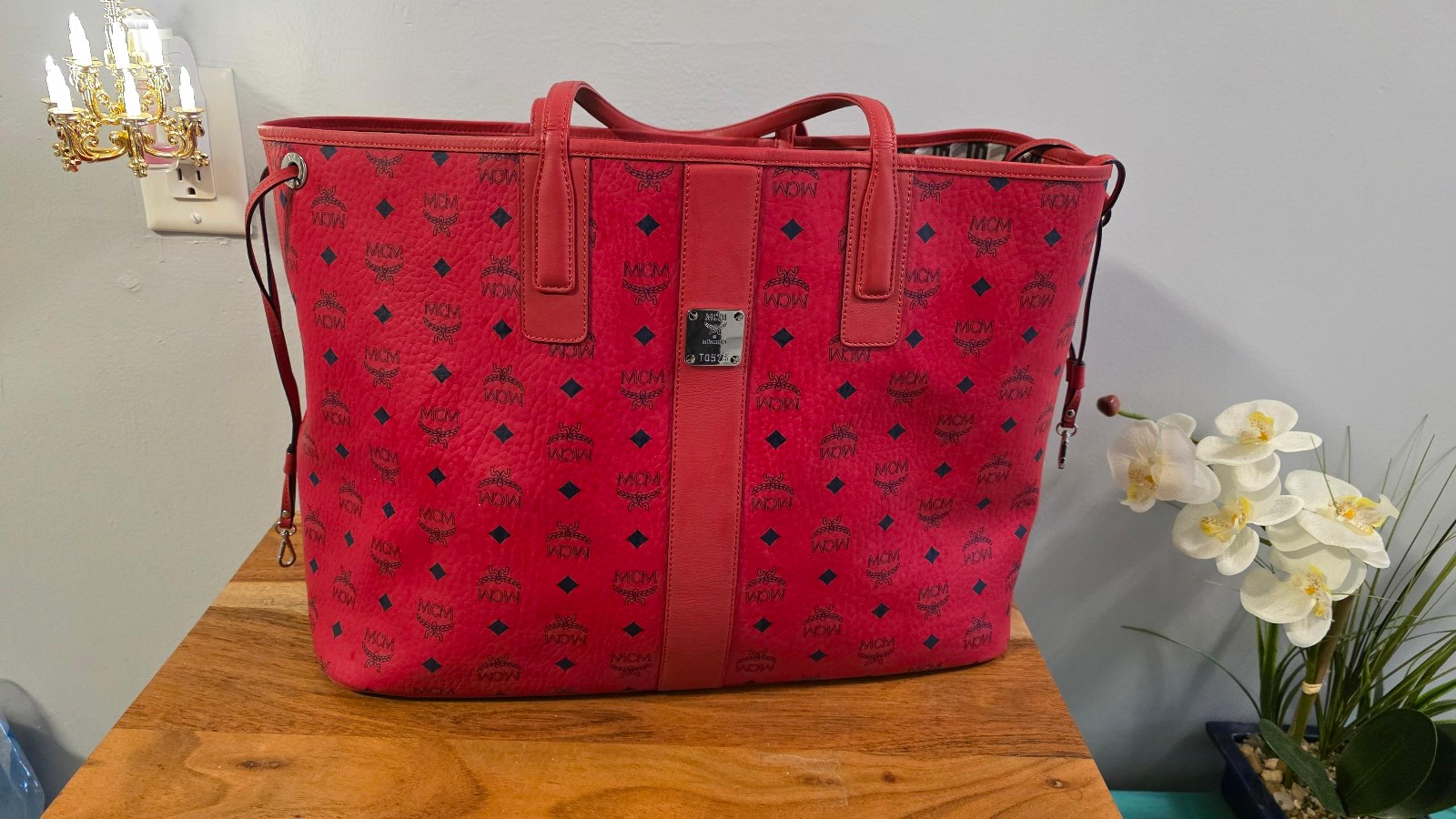 MCM Liz Reversible
Large Tote Candy Red includes Zip Pouch with wristlet strap.