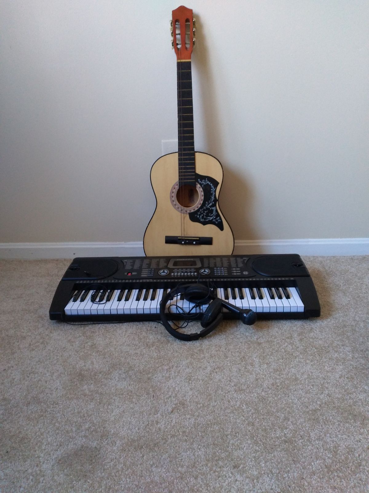 A guitar a piano 2 phones and a tablet