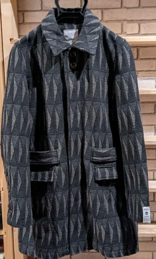 Shalife geometric pattern wool coat with waist belt.