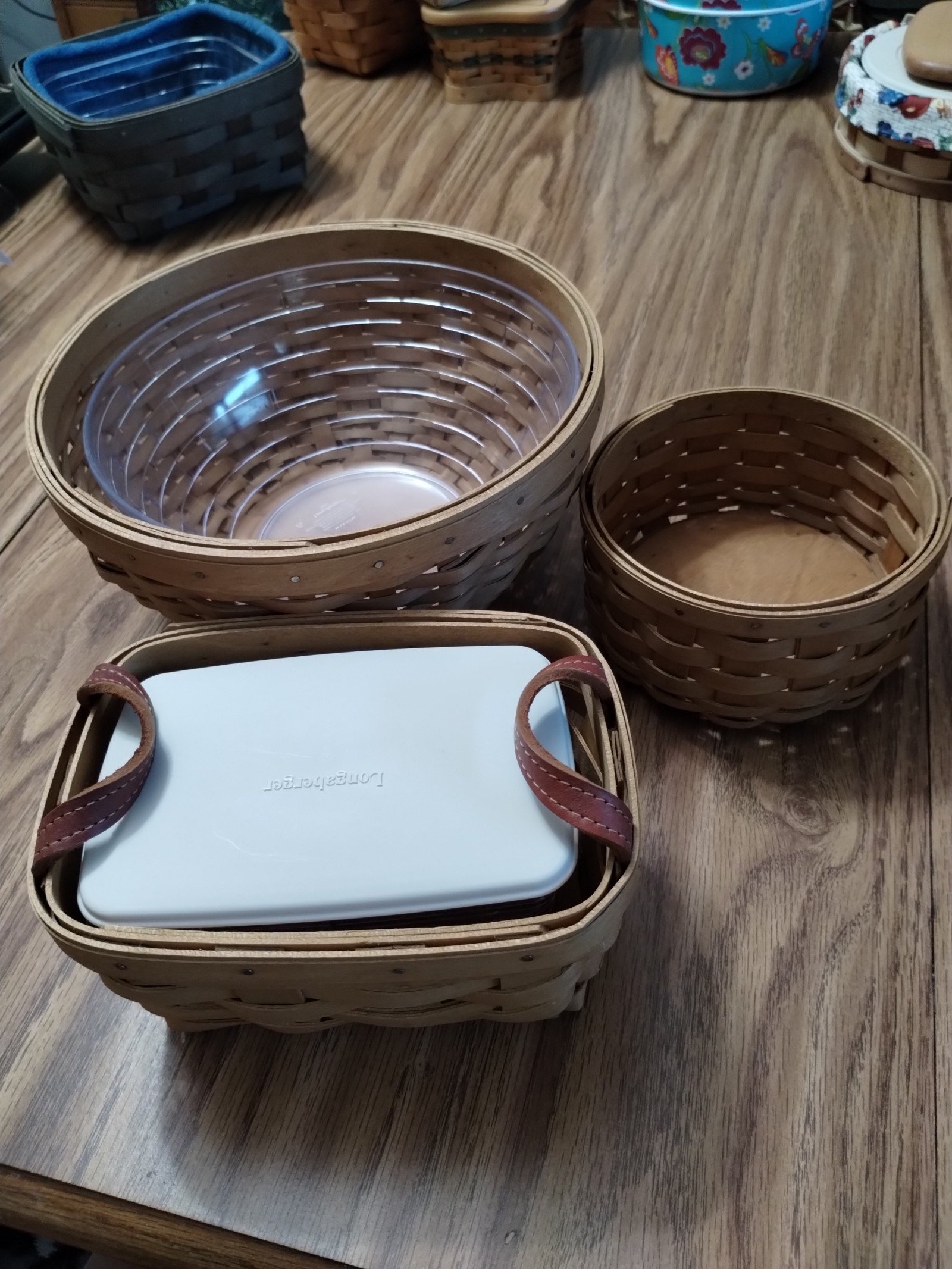 Longaberger baskets (3) tea with prot.& Lid, circular w/ hard prot & sm. Round