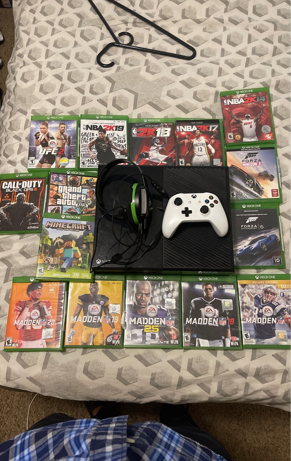 Xbox one with multiple games and two controllers with a mic