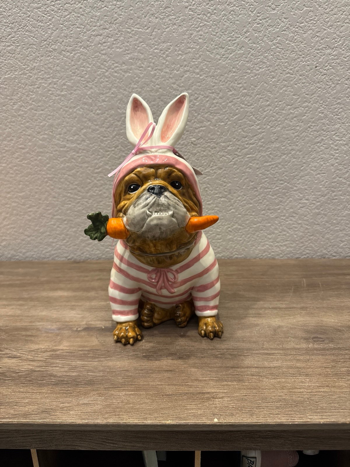 HTF blue sky Bulldog wearing an Easter bunny outfit holding a carrot canister .