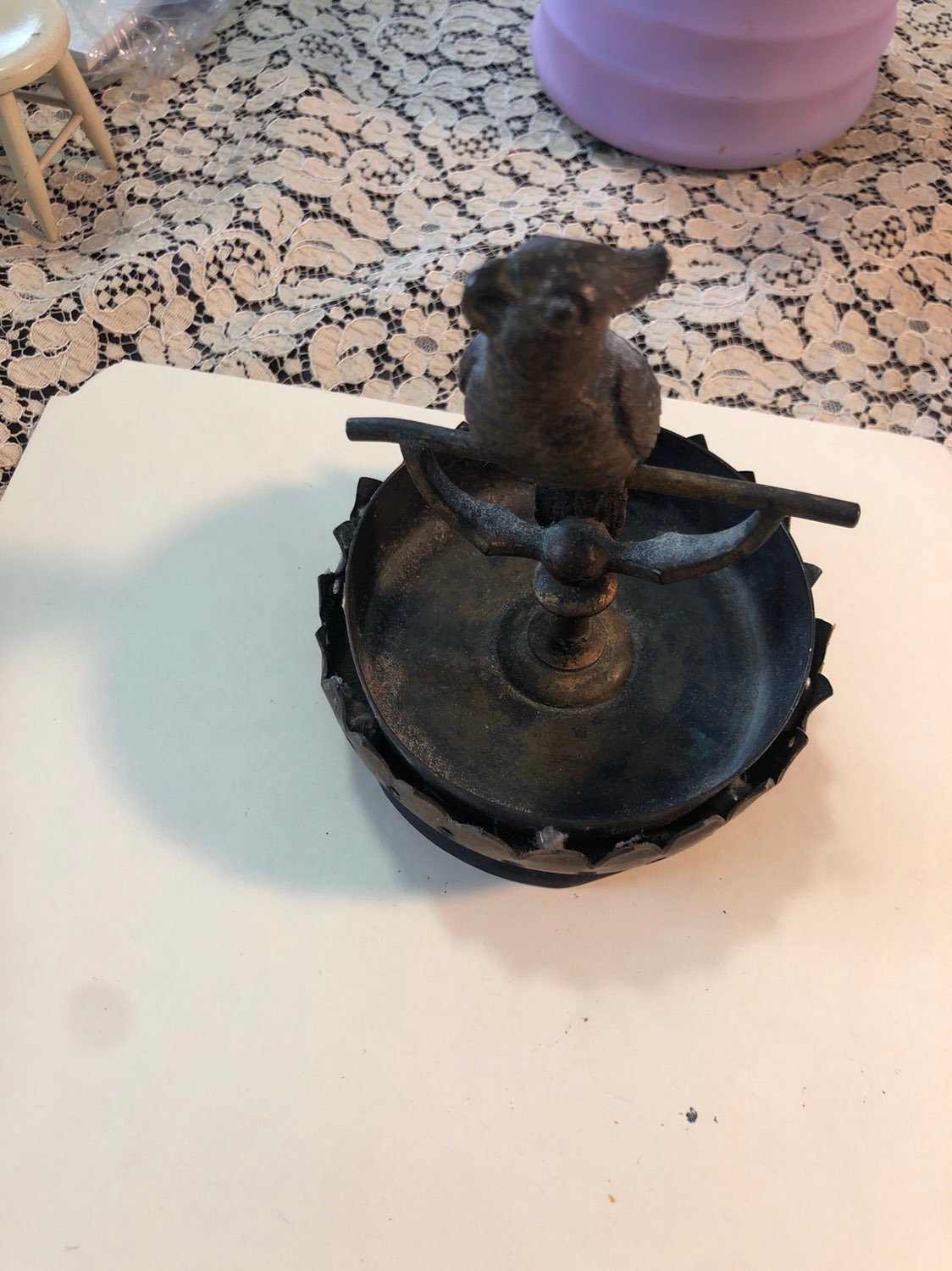 bronze parrot on a stand in bitd bath
