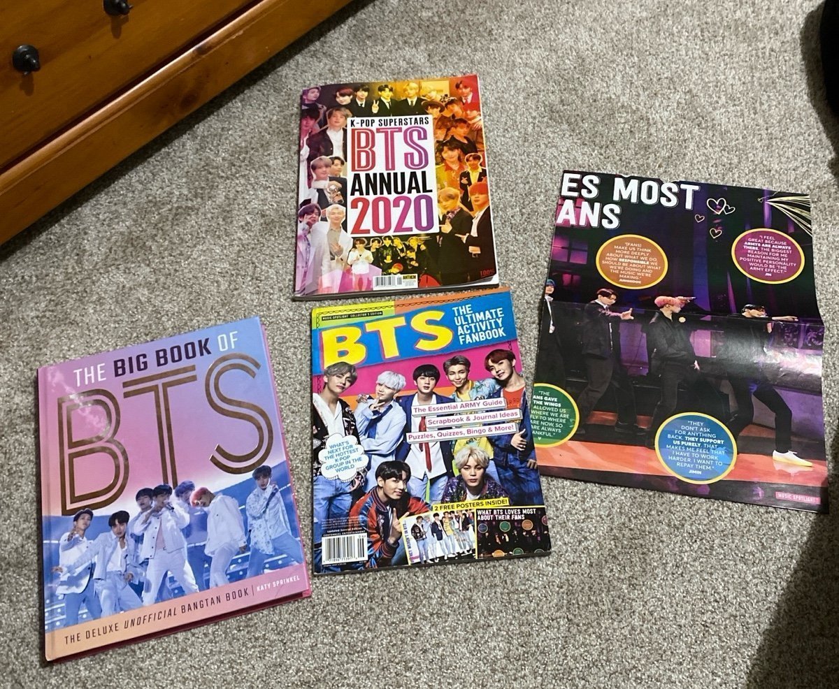 BTS books, a poster, doll, and accessories/cards