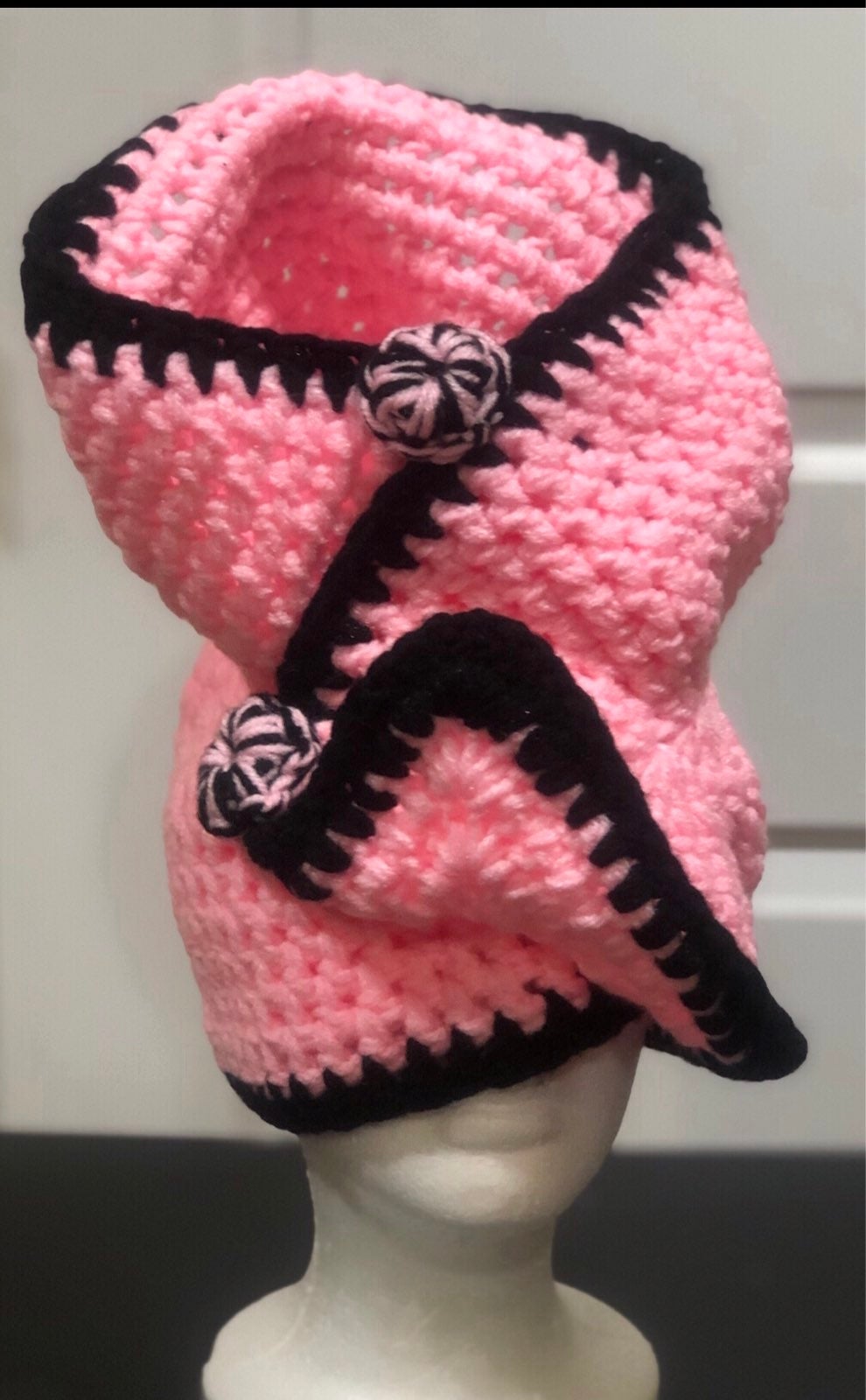 Hand made pink and black wrap hat with black and pink buttons.