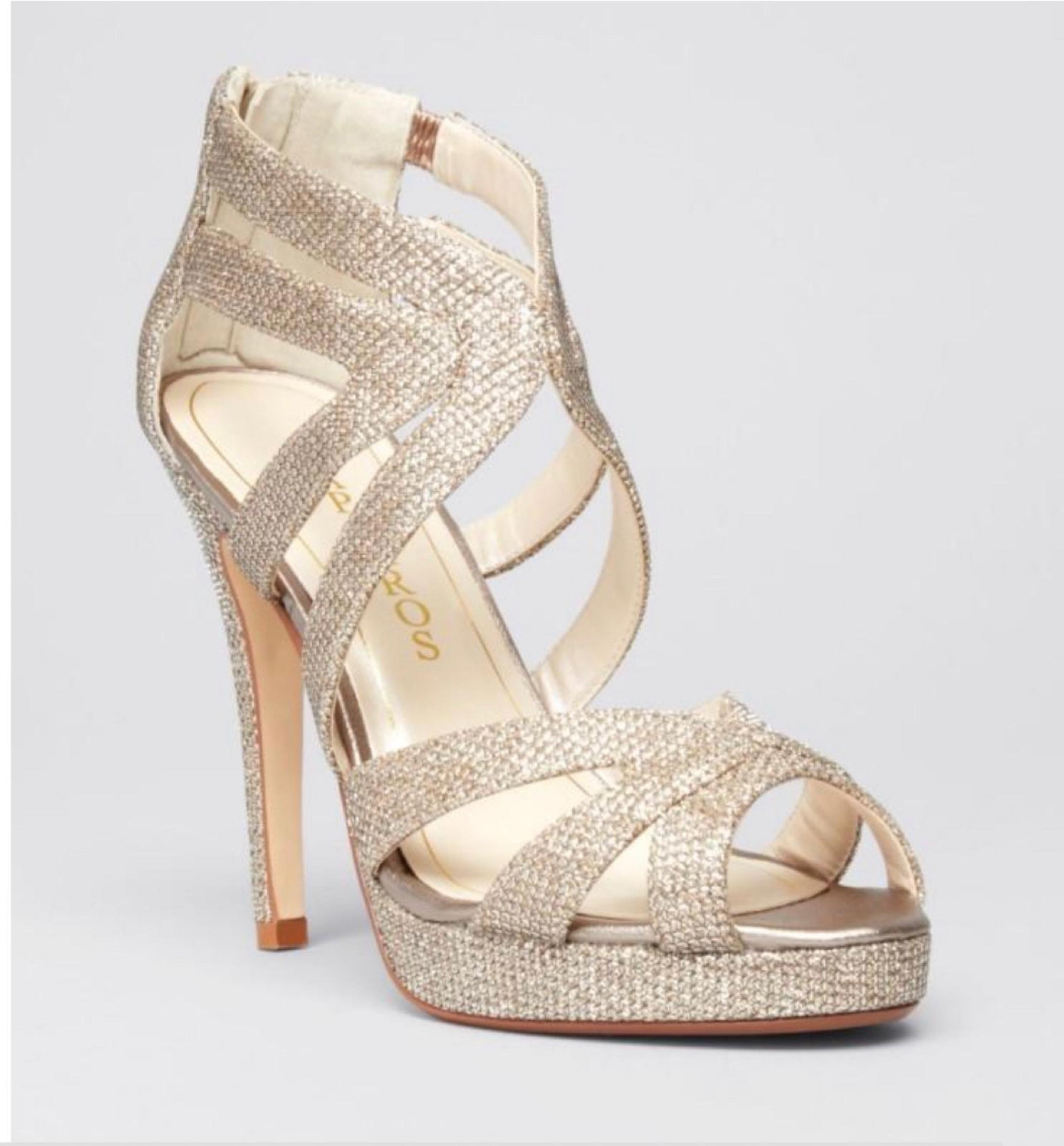 Caparros: Peep toe; functional back zip; glitter finish. 4.5" heel. Fabric upper