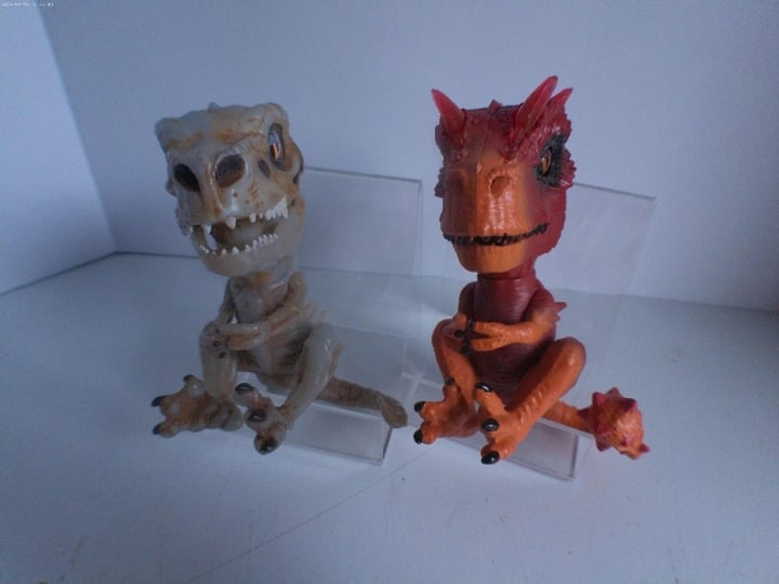 WowWee Fingerling's Untamed Skeleton Raptor Gloom Sand and Radioactive T- Rex