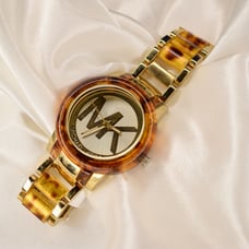 Women’s Gold Michael Kors clasp band style watch with tortoise shell details