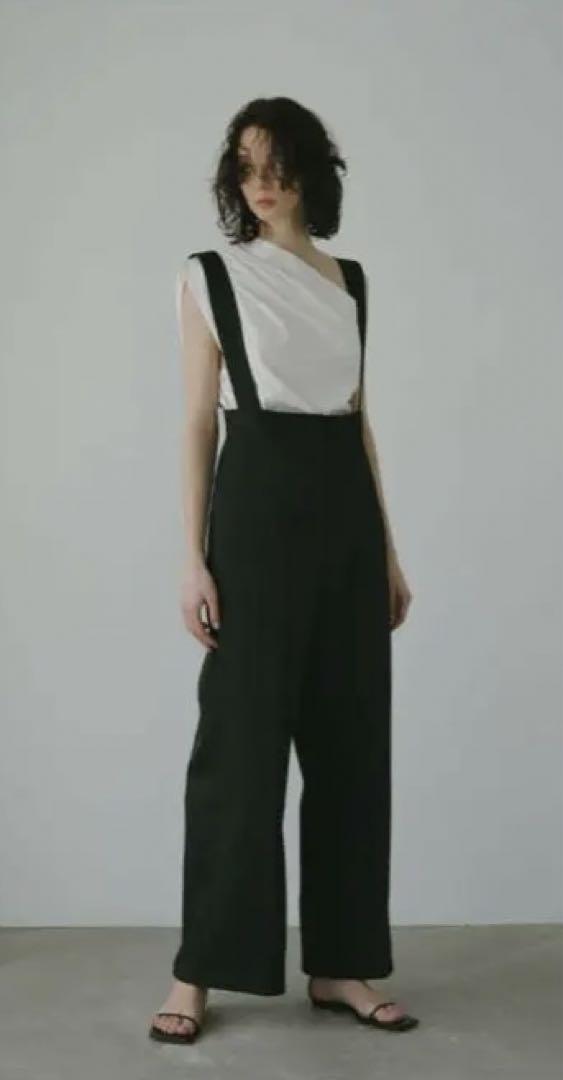 Black overall wide-leg pants with adjustable straps.