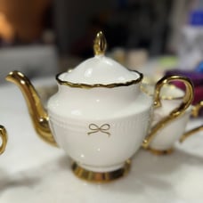 Gold and ivory bow teapot, sugar and milk set