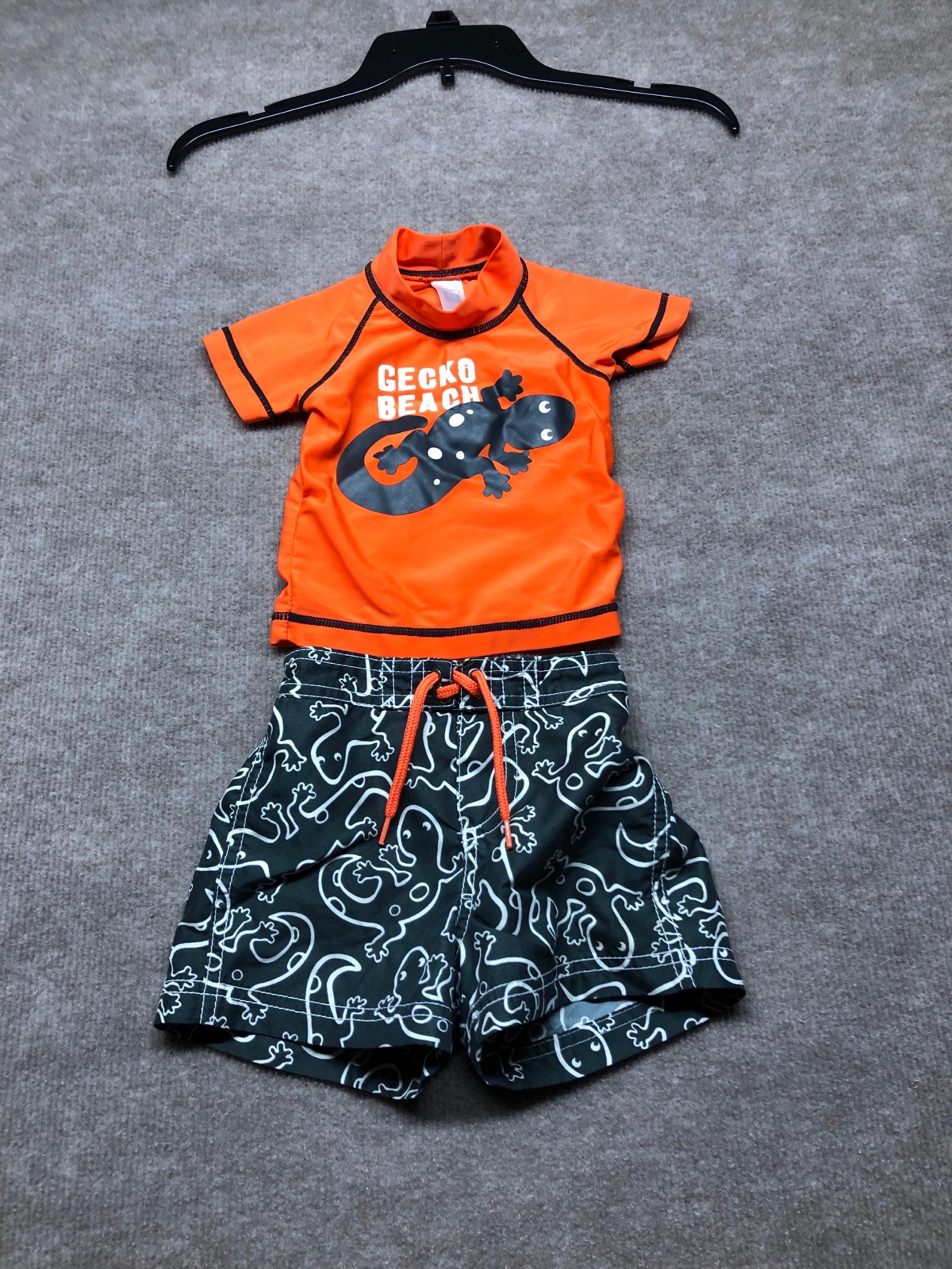 Carters black swim trunks with Gecko and orange swim shirt size 12 months