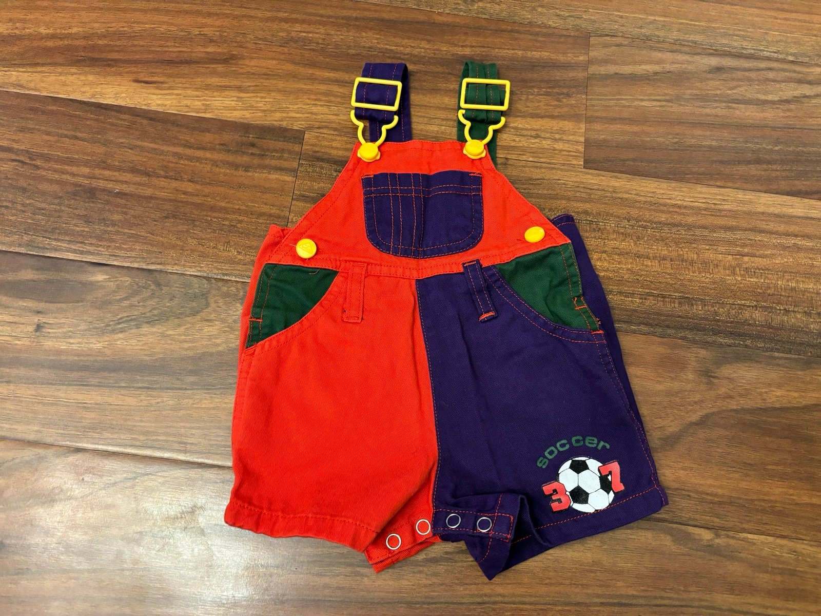Vintage Soccer red/purple/green overall shorts.