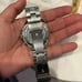 MK woman’s chrome watch