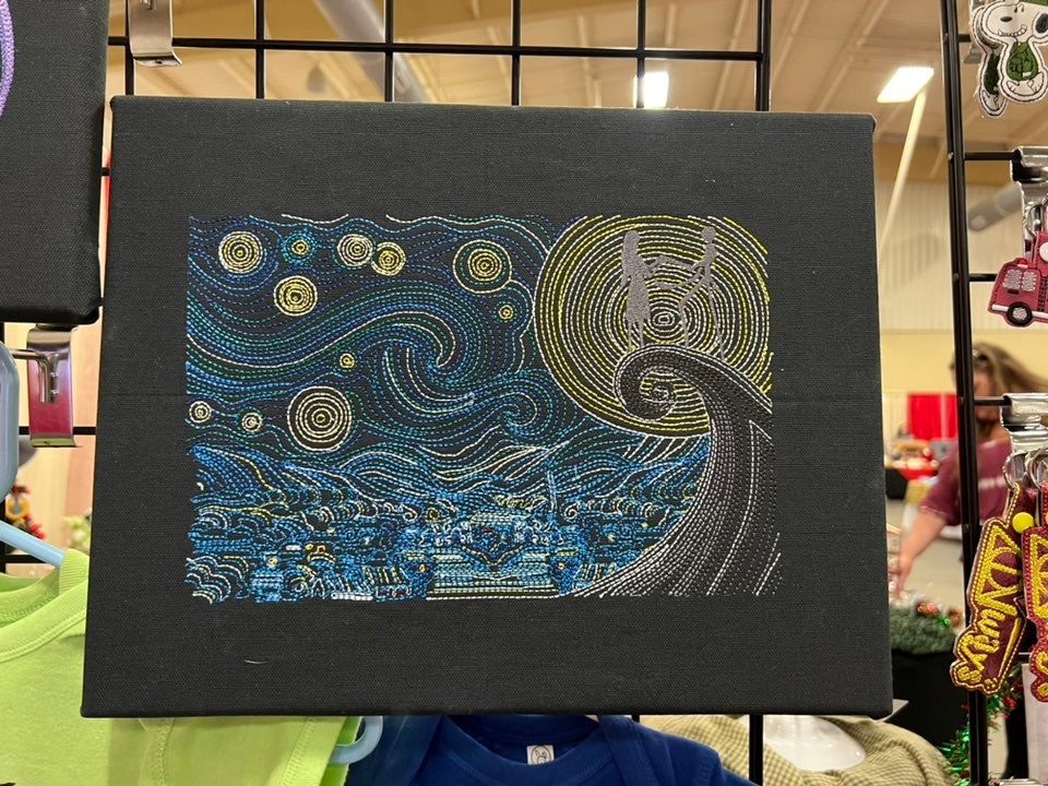 Embroidered artwork stitched on black canvas