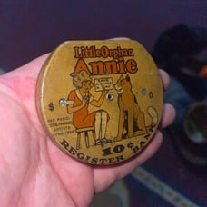 Little orphan Annie .10 cent antique coin bank, opens once you hit the 5.00