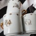 Vintage Looney Tunes 3 Tea Cups 2x3in & 4 Saucers 5in Dia White & Gold Inlay