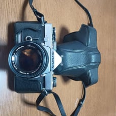 Olympus OM-1 film camera with Zuiko 50mm f/1.4 lens.