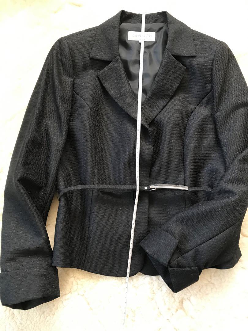 Black tailored jacket with a waist belt.