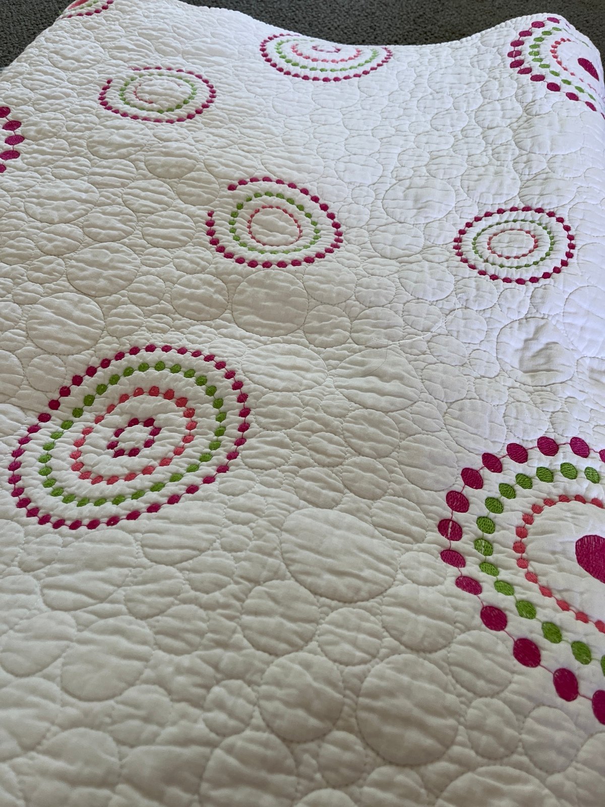 Twin coverlet with embroidered circle pattern and quilted sham
