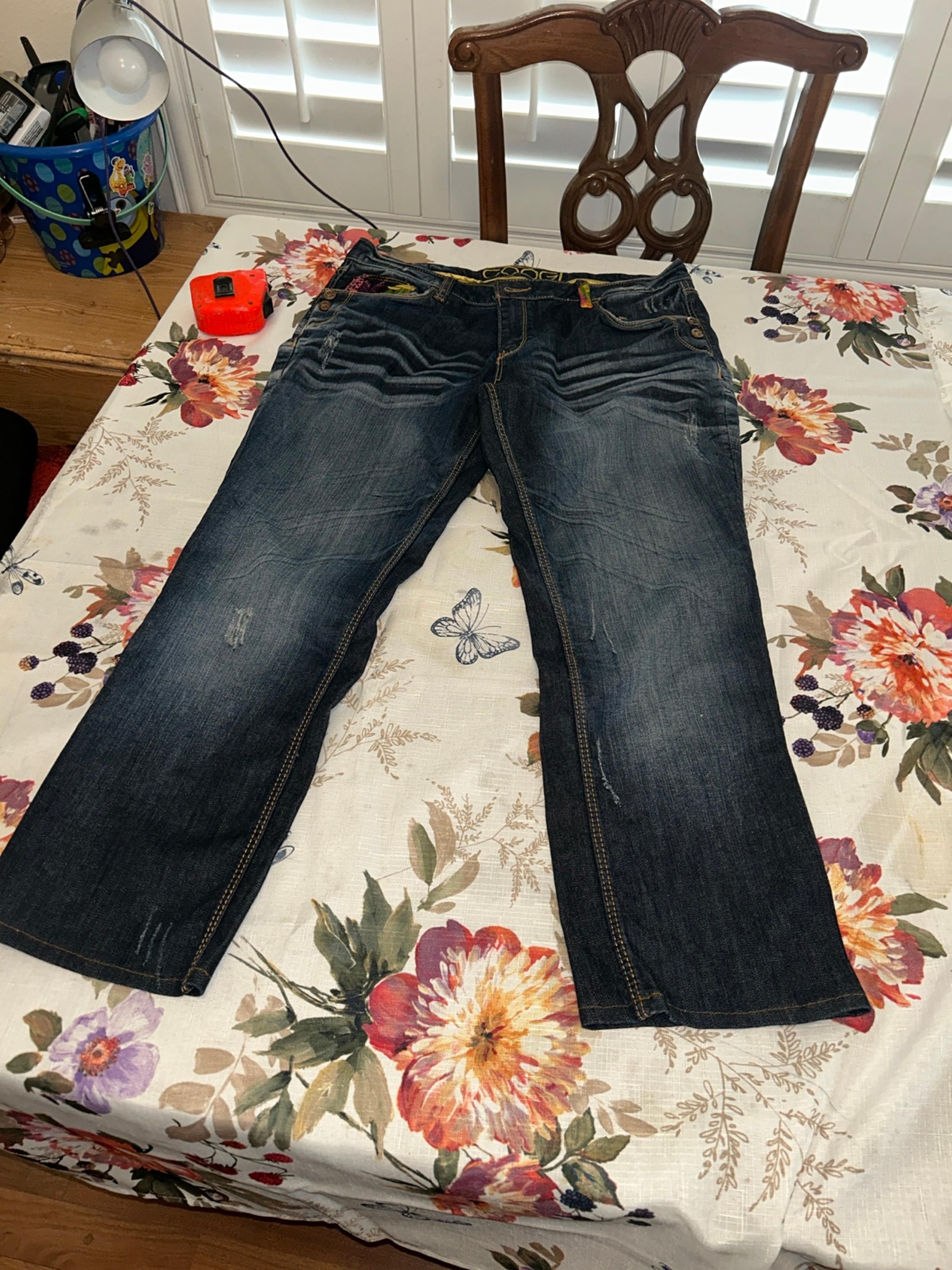 COOGI Stylish distressed blue jeans.