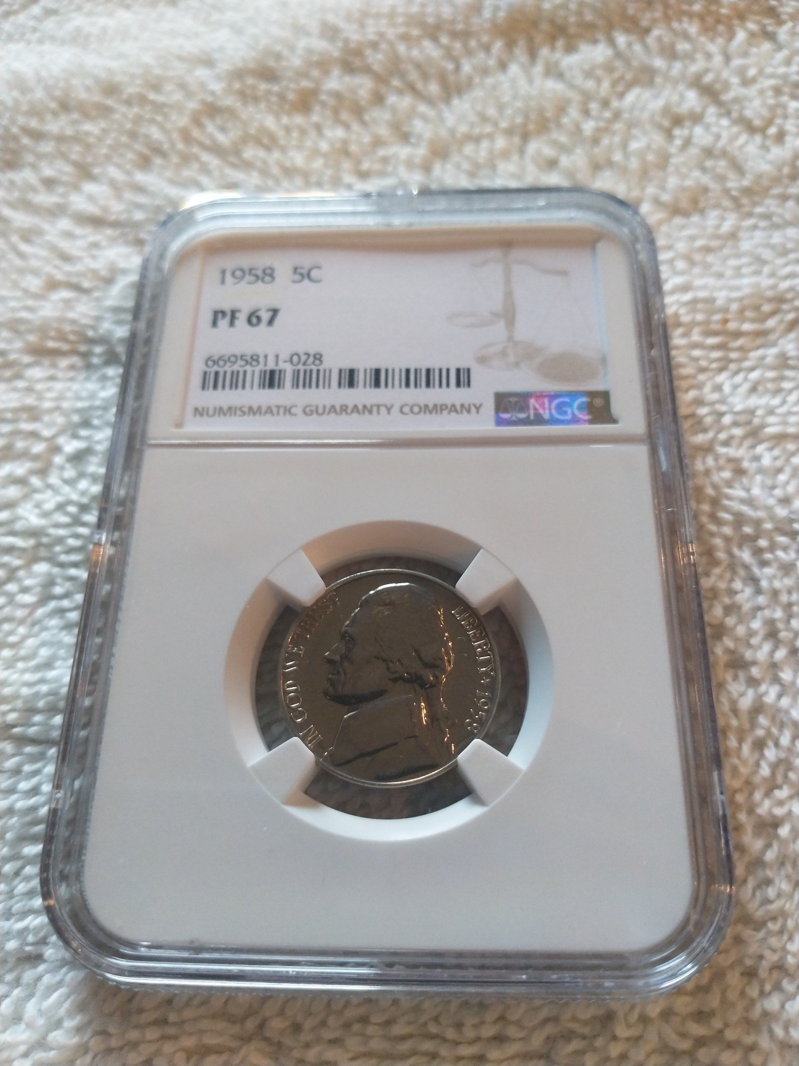 NGC 1958 5 cent prove 67 holder number 028