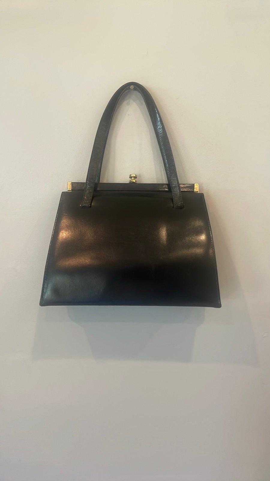 Vintage black patent leather handbag with gold accents