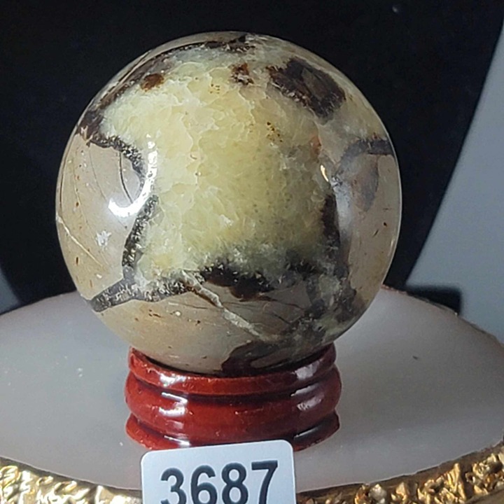NATURAL SEPTARIAN SPHERE WITH UV REACTION AND WOOD HOLDER #3687