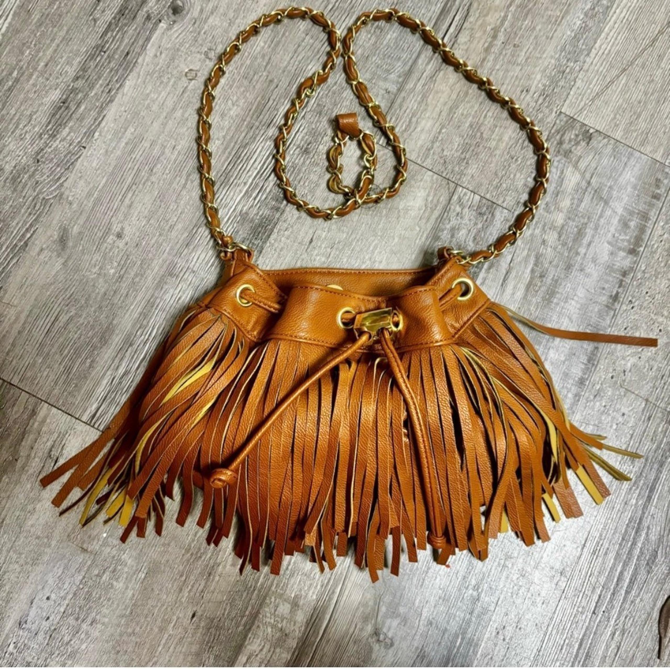 Olivia + Joy Brown Fringe Drawstring Crossbody Satchel Purse with chain strap.