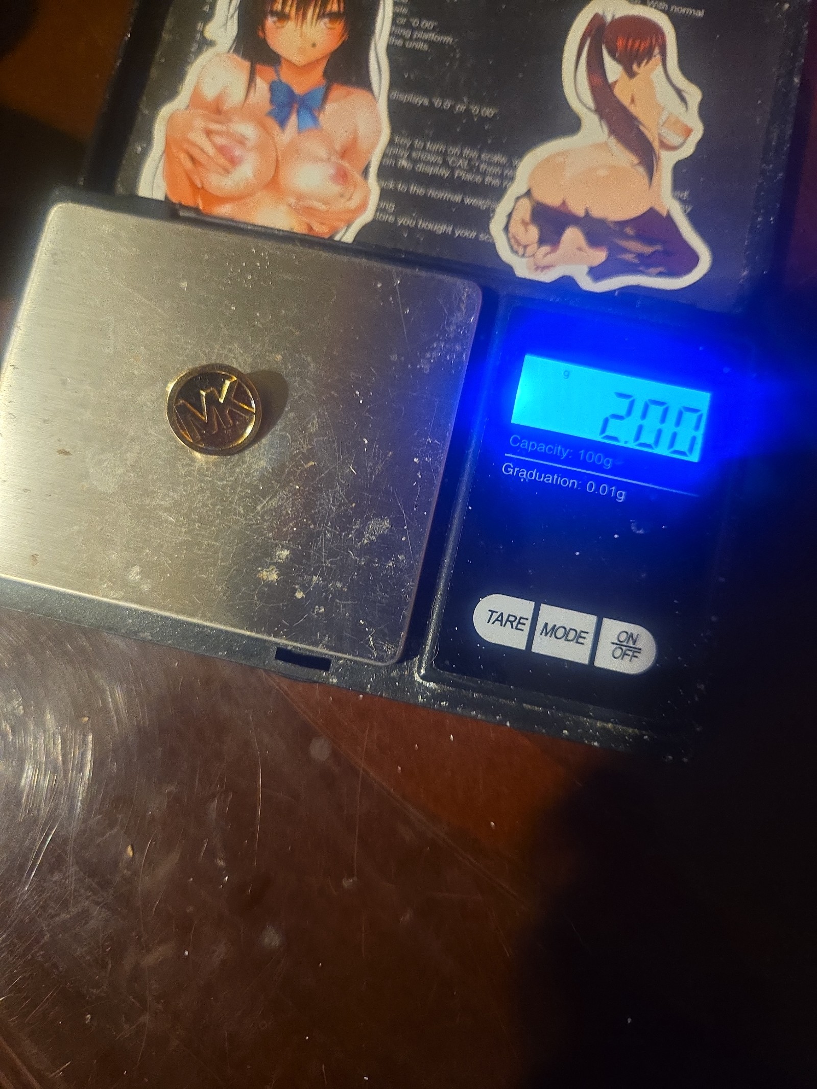 gold MK coat button