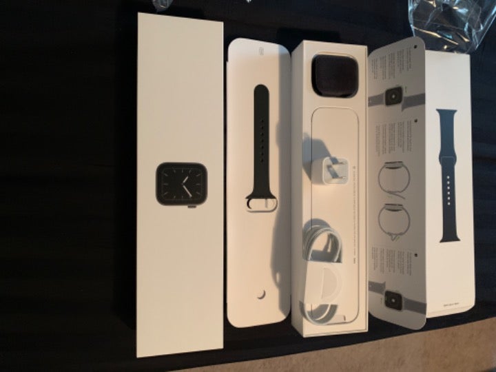 Apple Watch charger, band, and boxes