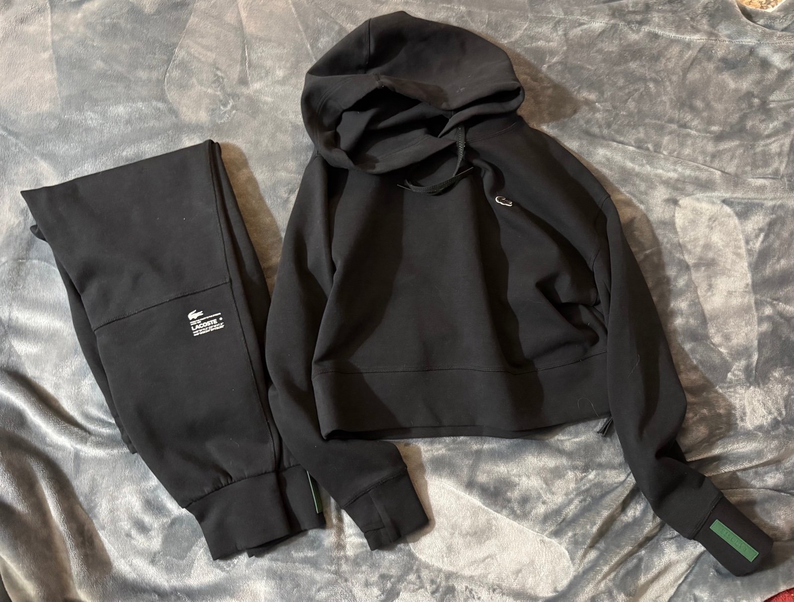 Women’s Lacoste black sweatsuit: hoodie and sweatpants.