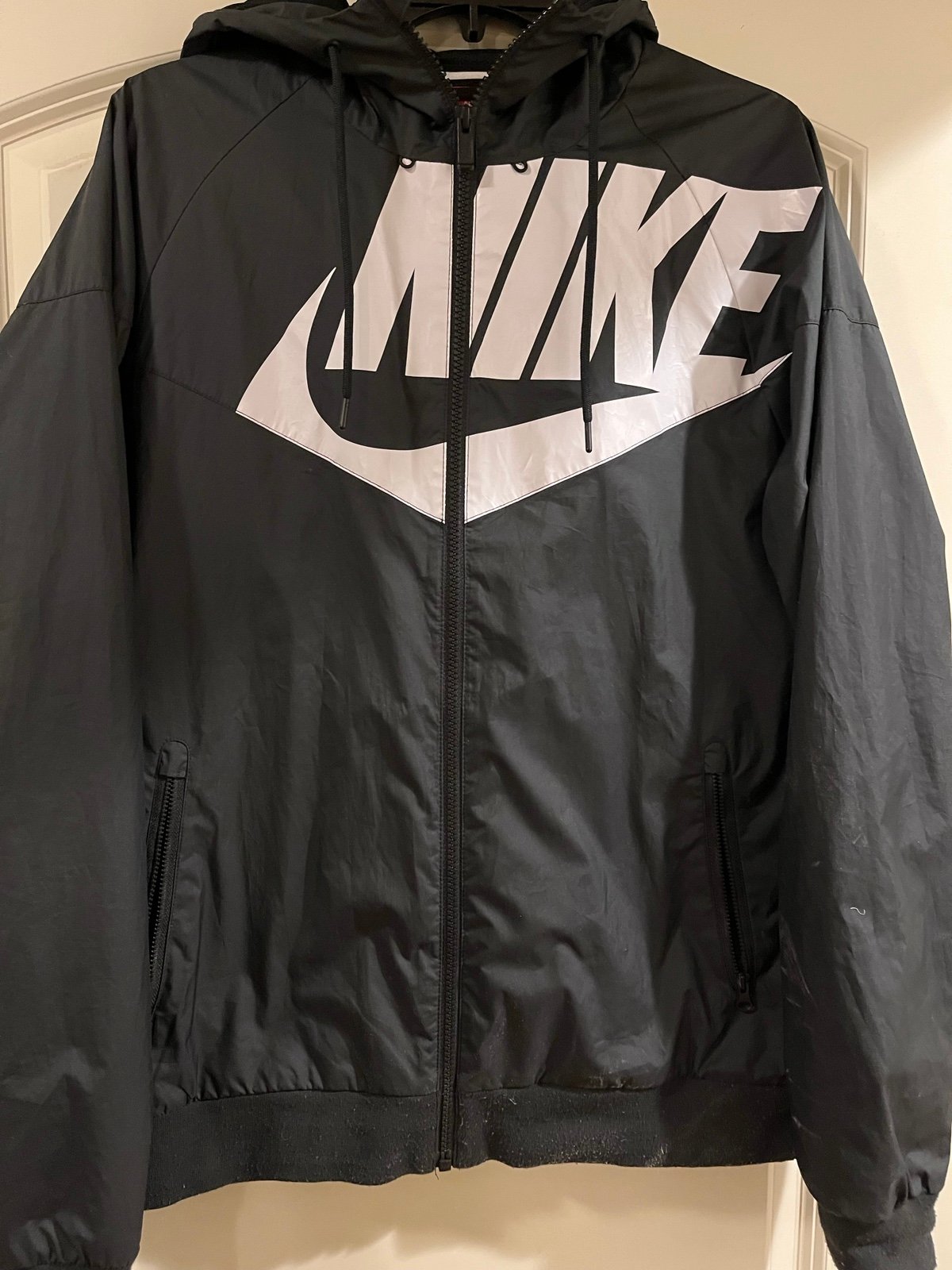 Nike rain jacket/windbreaker. Appropriate for male or female.