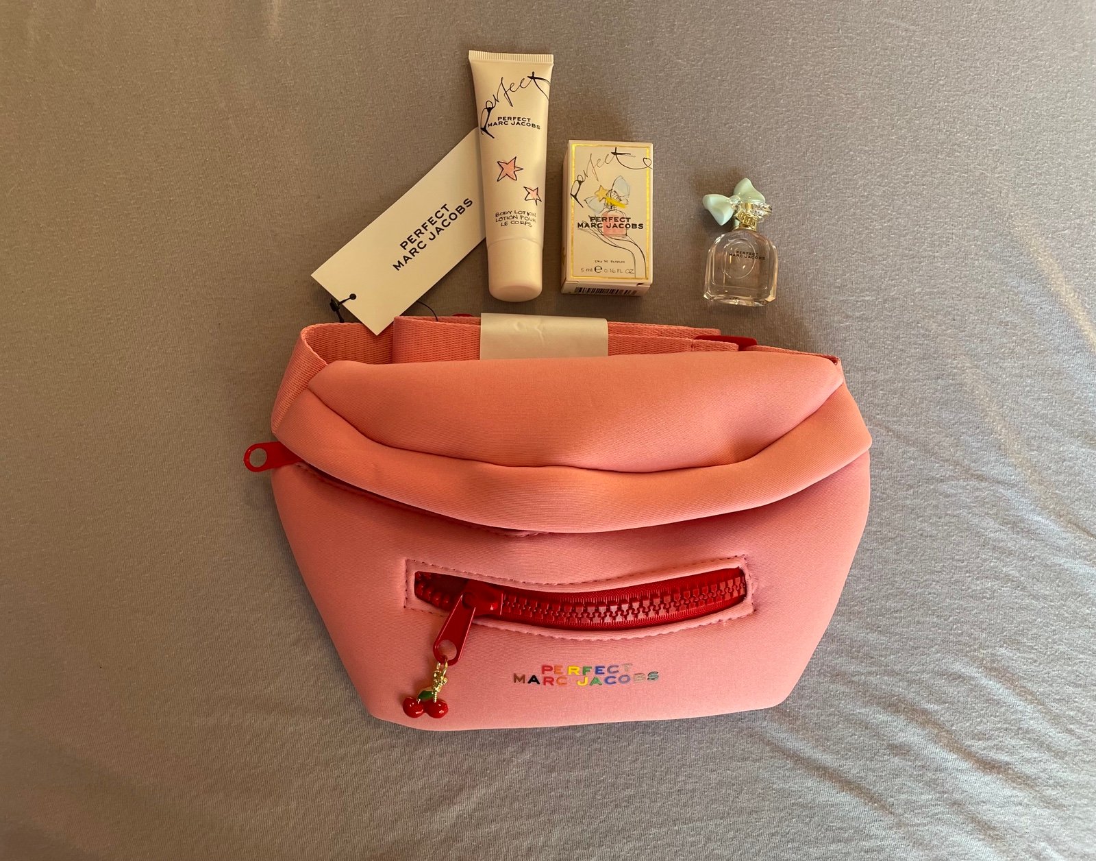 Marc Jacobs belt bag with body lotion and perfume