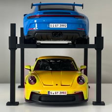 Two 1/18 scale Diecast Porsche 911 gt3 and 4 post car lift display blue yellow