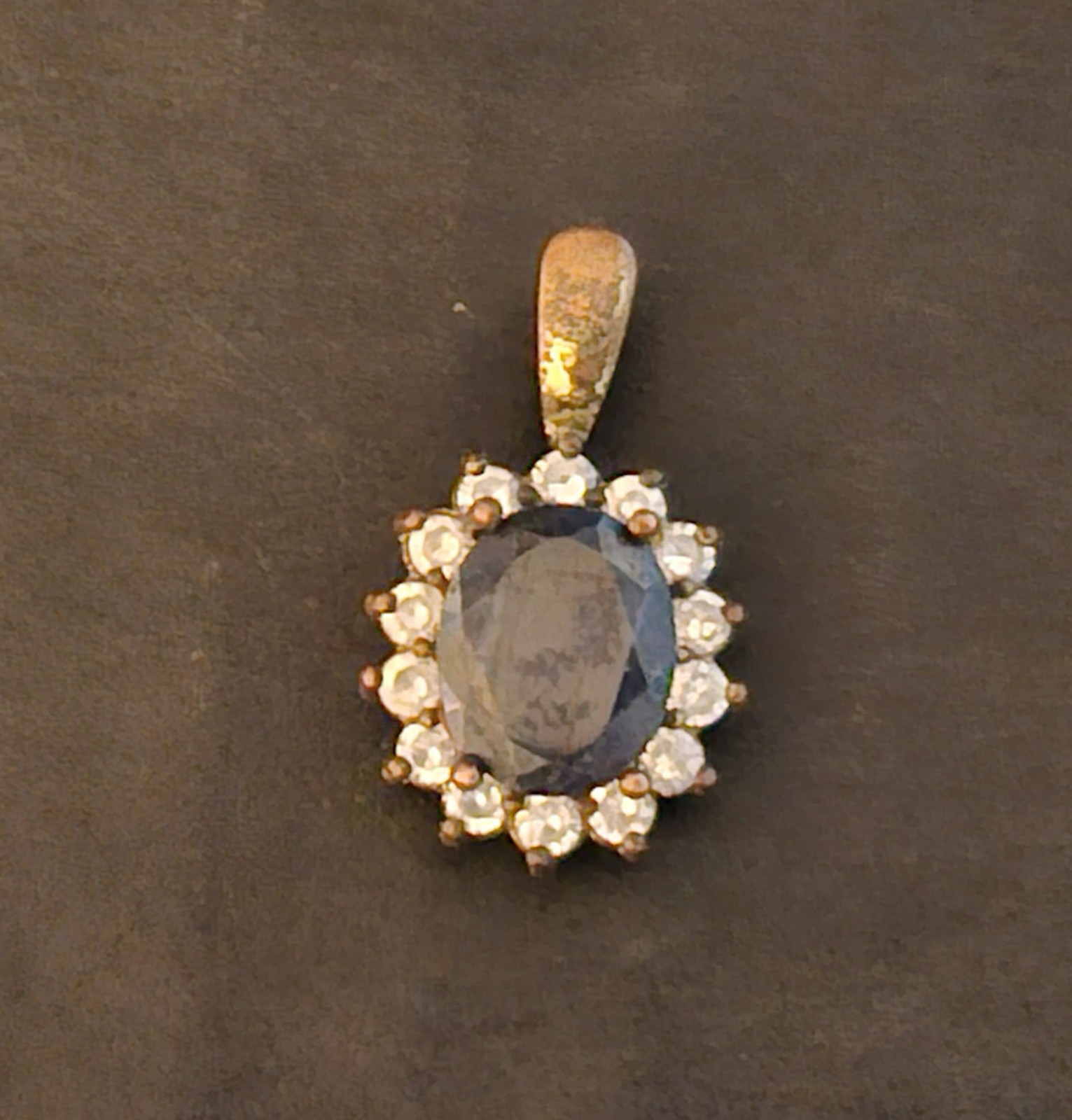 Blue Sapphire Pendant surrounded by smaller white stones, set in a
