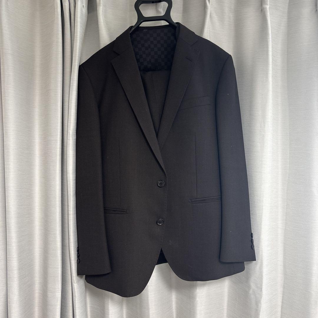 Dark brown business suit with a vest.