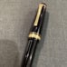 Japanese-made black ballpoint pen with gold accents, Sailor.