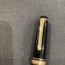 Japanese-made black ballpoint pen with gold accents, Sailor.