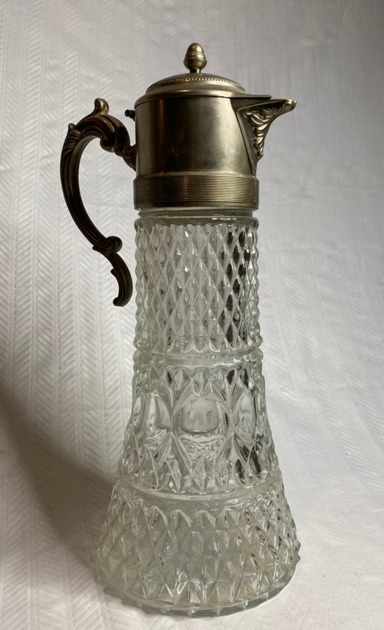 Antique pitcher cut crystal silver top.