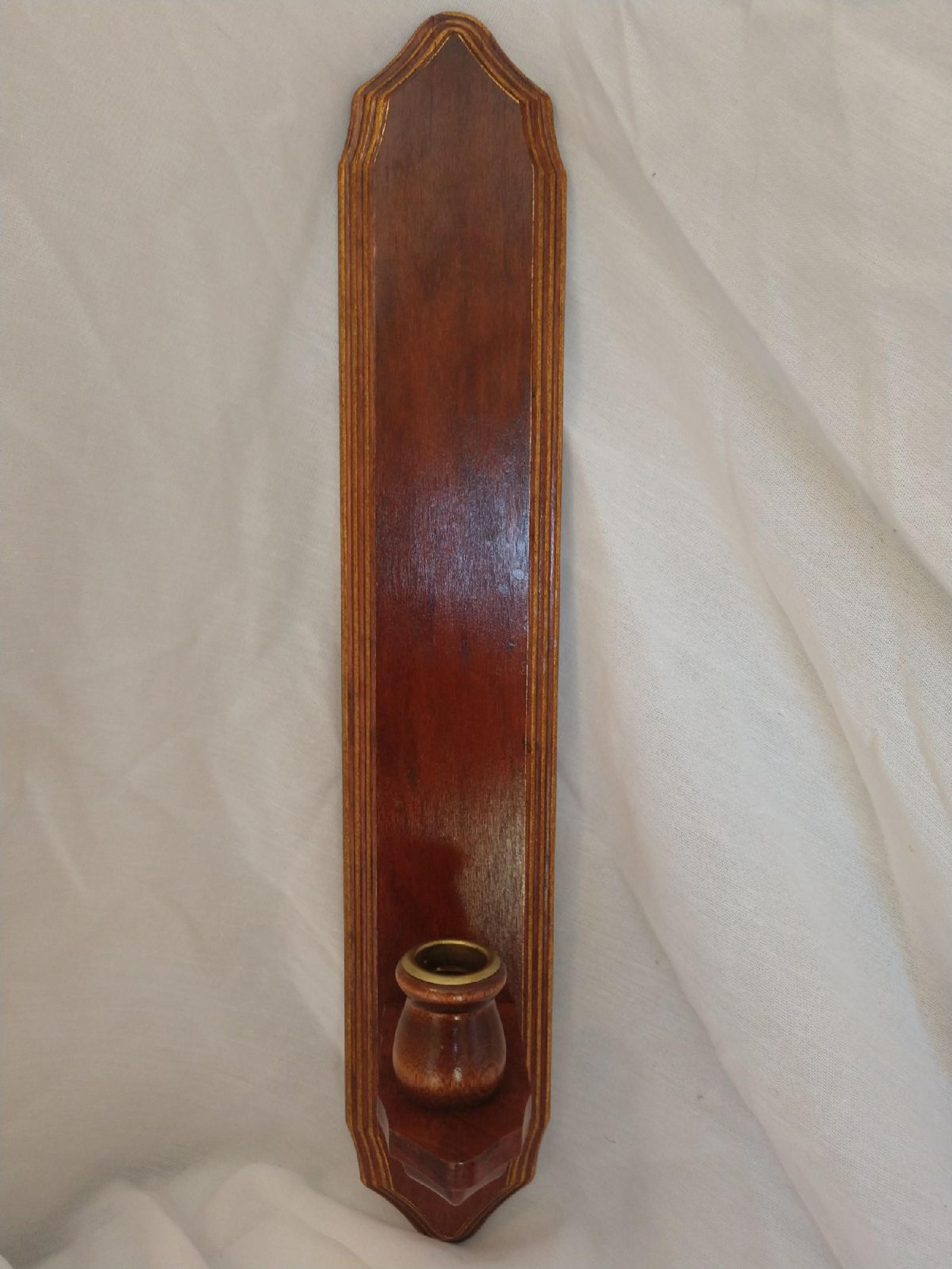 Wood sconce with votive cup.