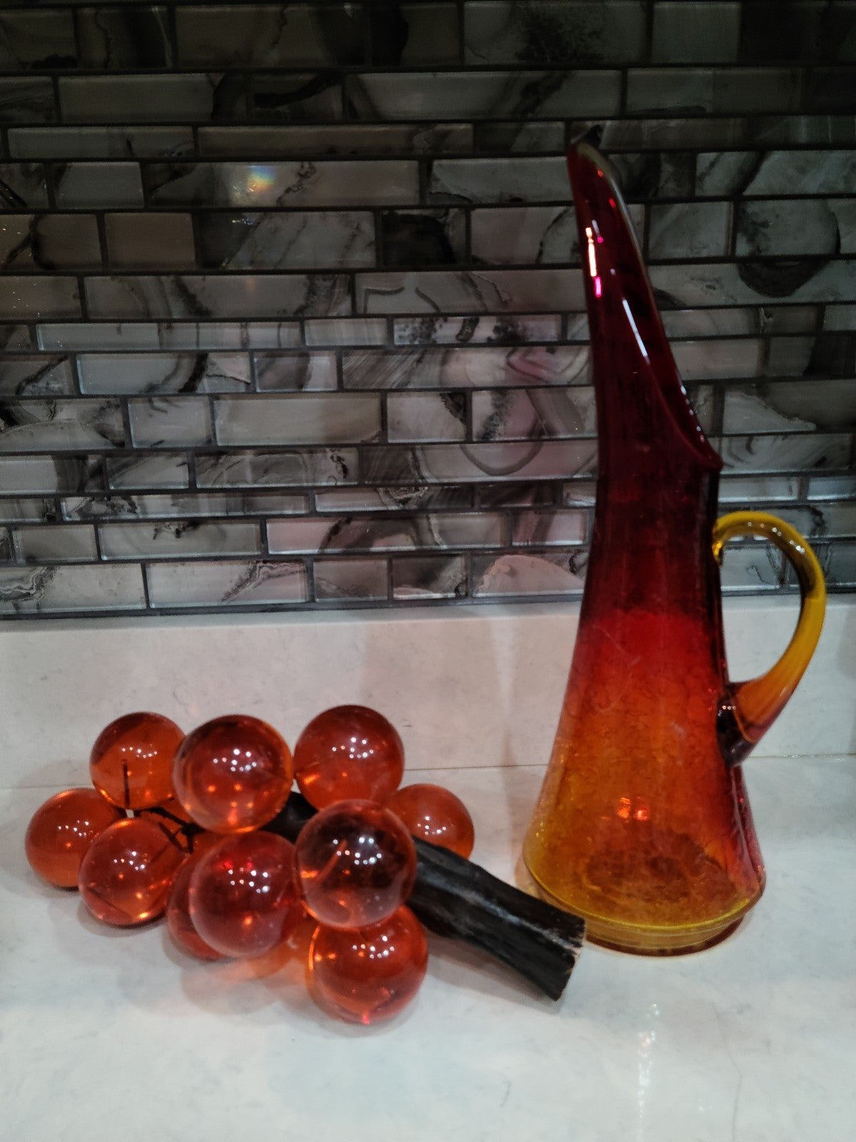 Vintage Grapes and Vintage Mid-Century Orange Crackle Glass Pitcher .