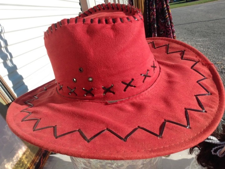 Red felt cowboy hat with black oversize size stitching