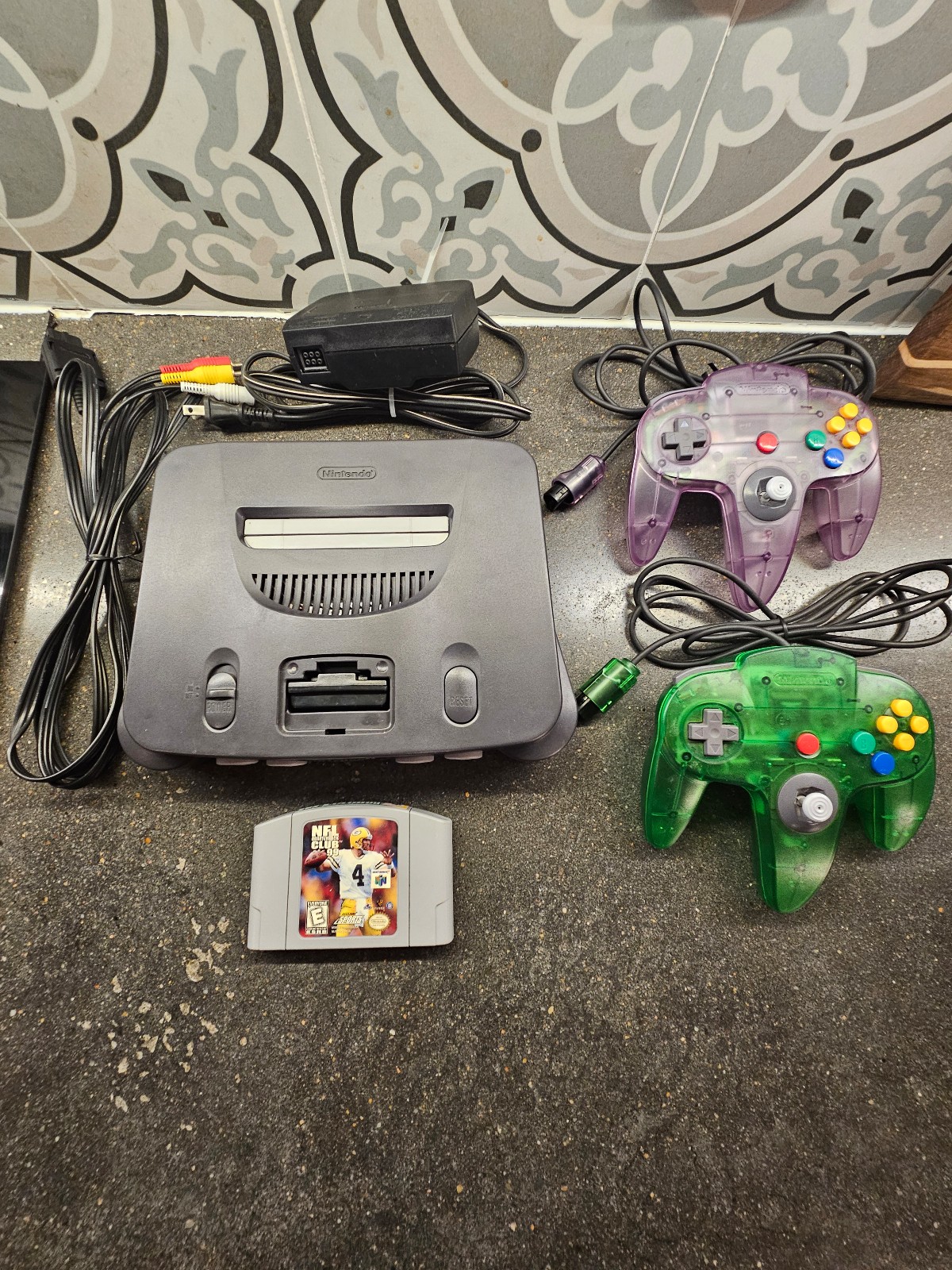 Nintendo 64 with Jungle Green, Atomic Purple Controllers, and 1 Game