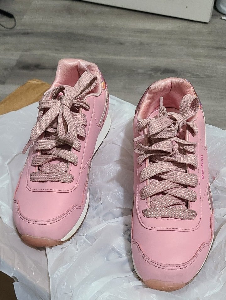 These are pink & white Reebok shoes for girls in good condition. (Size 2)